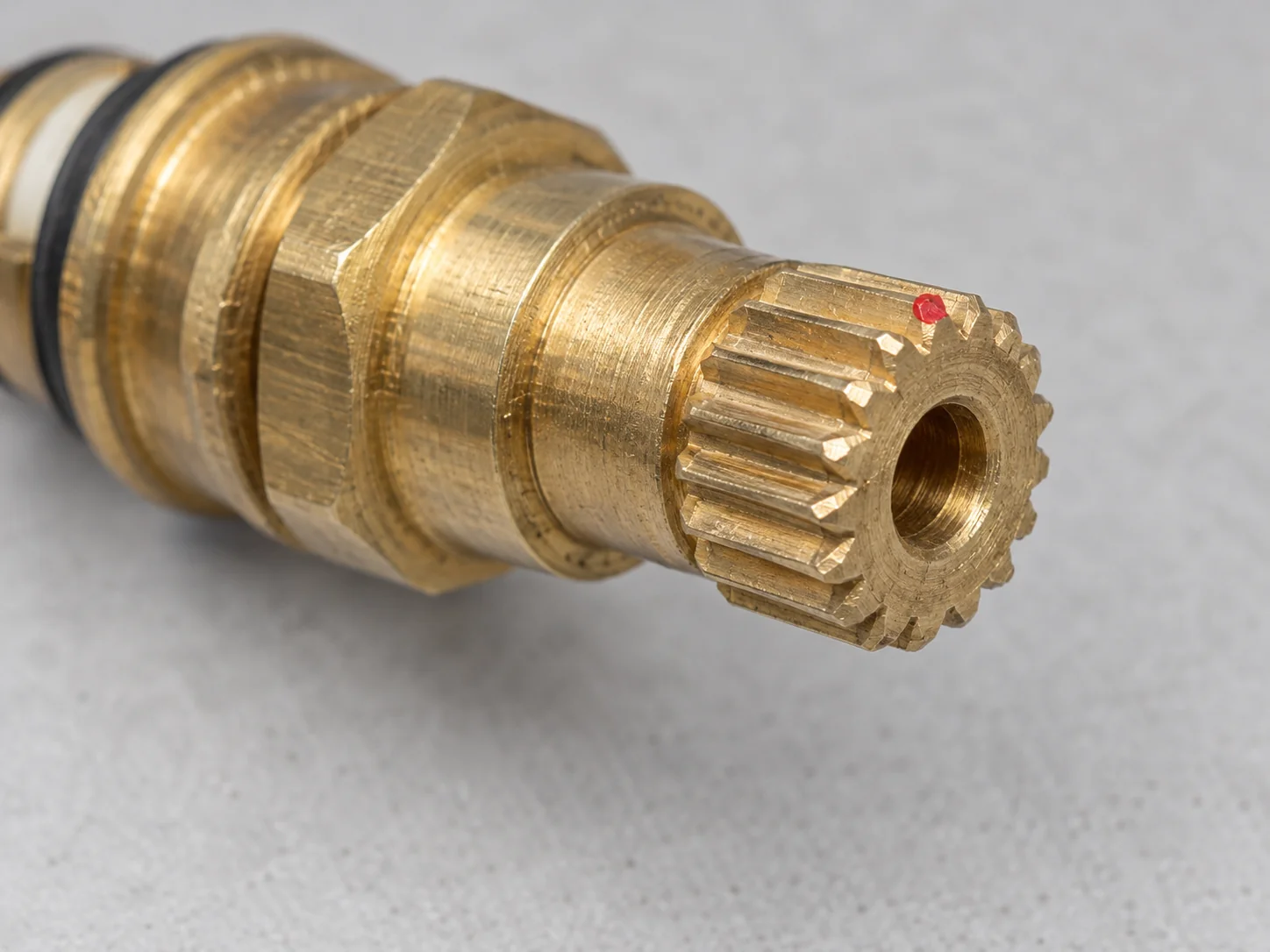 The splined end of a faucet stem close up, showing the pointed ridges that are counted to find the broach